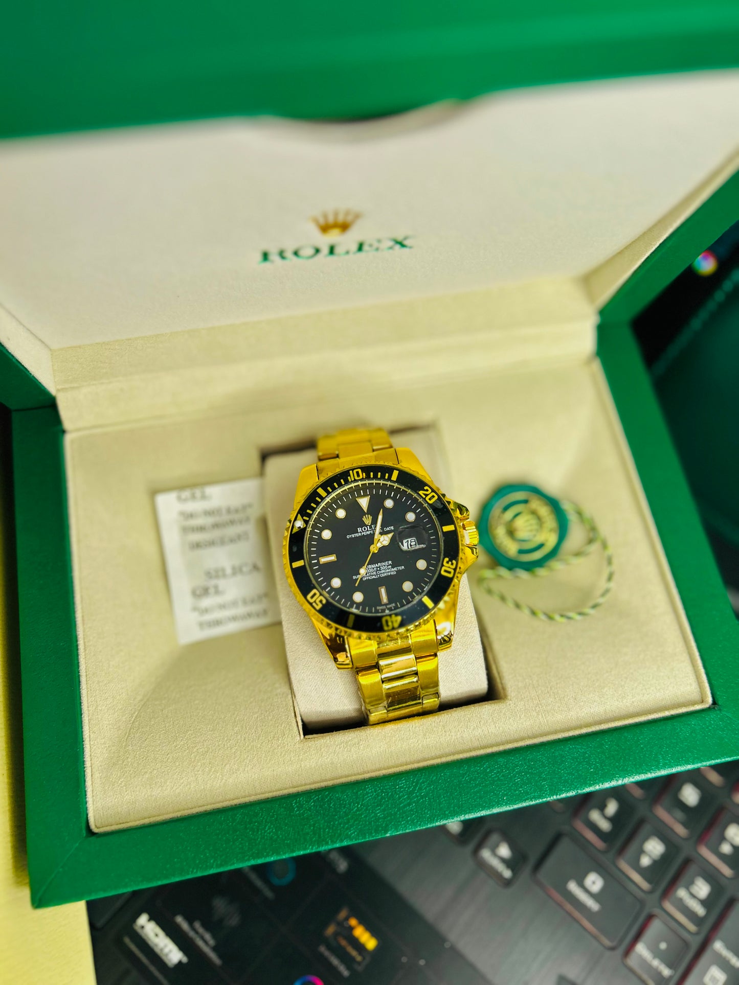 Black Submariner Dial Watch with Gold Chain & Original Rolex Box