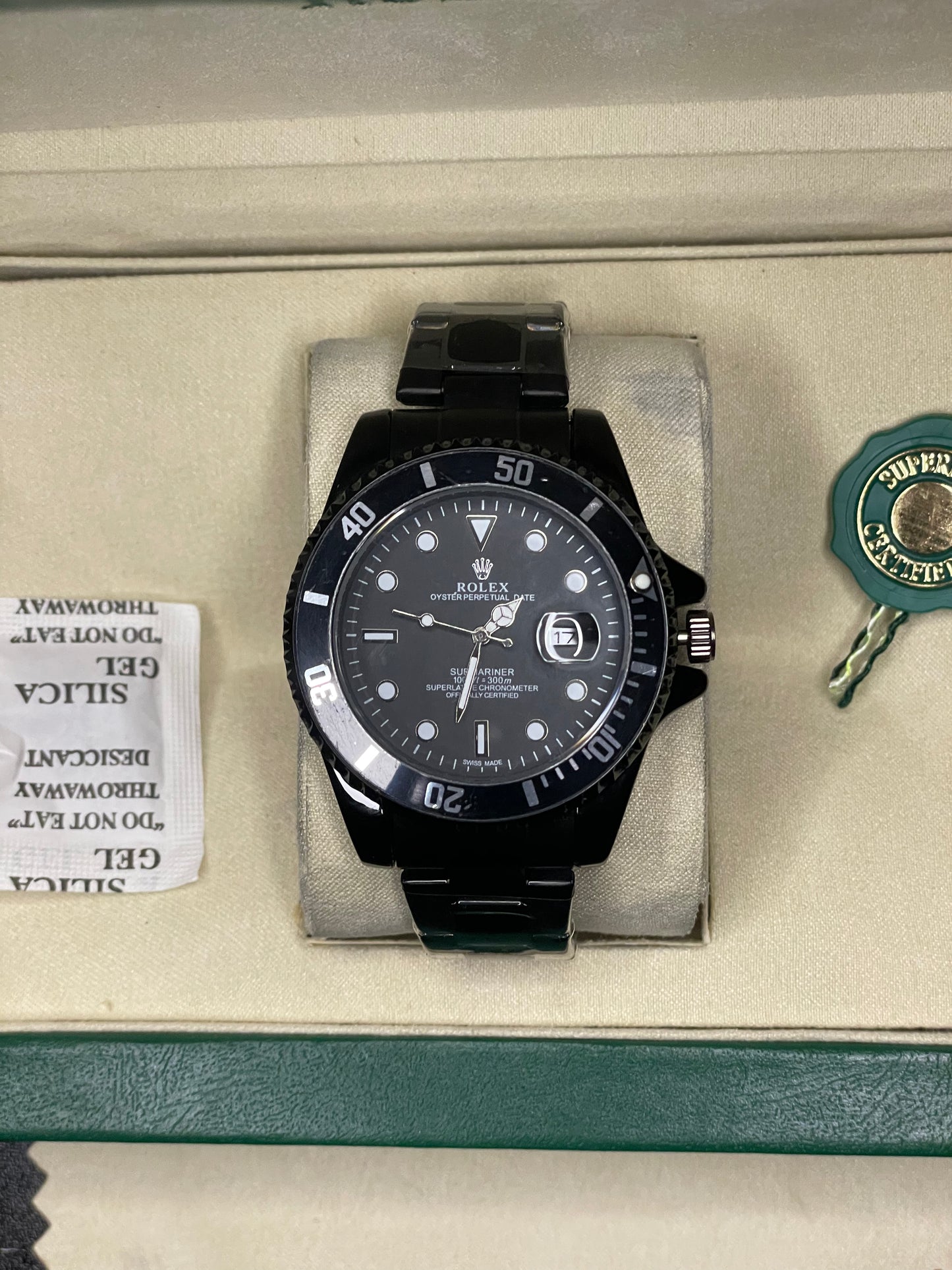 Rolex watch in a green box on a dark surface