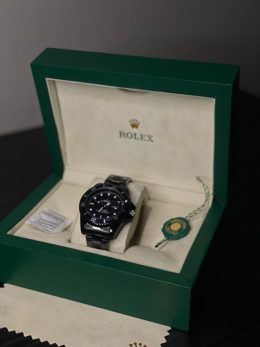Rolex watch in a green box on a dark surface